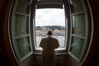 Standing in the window of the library of the Apostolic Palace overlooking an empty St. Peter&#039;s Square, March 29, 2020, Pope Francis blesses the city of Rome, still under lockdown to prevent the spread of the coronavirus.
