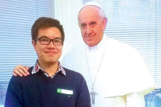 Michael Chen, with a cutout of Pope Francis, at the Jesuit retreat he took part in earlier this year.