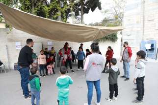 Caritas staff work with children who have been left homeless by the war in Gaza.