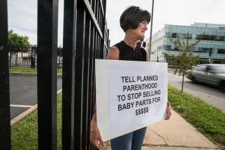 Bev Ehlen, state director of Concerned Women for America, holds a sign outside of a Planned Parenthood facility in St. Louis July 21. She was among several pro-life supporters demonstrating after the release of two videos that showed Planned Parenthood o fficials discussing the method and price of providing fetal tissue obtained from abortions for medical research. 