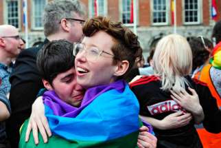 People embrace as the final vote of the referendum on same-sex marriage is announced May 23 in Dublin. Archbishop Eamon Martin of Armagh, Northern Ireland, president of the Irish bishops&#039; conference, says the church must do more to reach out to gay people.