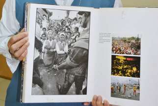 Sister Porferia Ocariza, a member of the Daughters of St. Paul, holds a book on the People Power uprising in the Philippines 30 years ago to oust dictator Ferdinand Marcos. She is still recognized today for her stunned expression, left image, as military tanks approached.