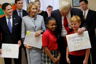 U.S. President Donald Trump chats with students from St. Andrew Catholic School in Orlando, Fla., March 3. U.S. Sen. Marco Rubio, R-Fla., and U.S. Education Secretary Betsy DeVos also joined the president.