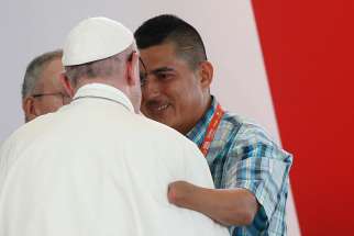 Pope Francis embraces man who spoke during a national reconciliation prayer meeting at Las Malocas Park in Villavicencio, Colombia, Sept. 8. 