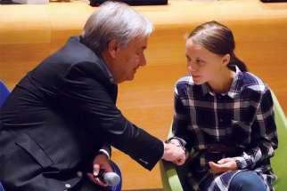 UN Secretary-General Antonio Guterres greets 16-year-old Swedish climate activist Greta Thunberg Sept. 21 during the Youth Climate Summit at UN headquarters in New York City.