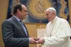 Pope Francis exchanges gifts with French President Francois Hollande at the Vatican Aug. 17.