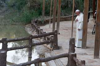 Pope Francis makes the Sign of the Cross after praying as he visits Bethany Beyond the Jordan May 24, believed to be where Jesus was baptized, southwest of Amman.