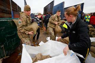 Local volunteers and the British Army fill sandbags Dec. 28 to stem floodwater in York, England. Pope Francis called on Christians to pray for victims of several natural disasters that have hit parts of the United States, Great Britain and Paraguay.