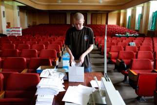 A worker at the election commission headquarters in Donetsk, Ukraine, arranges referendum materials May 8. Ukrainian Catholic bishops said the country&#039;s planned May 25 presidential election must proceed, despite violence designed to derail it.