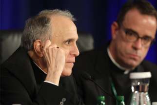 Cardinal Daniel N. DiNardo of Galveston-Houston, president of the U.S. Conference of Catholic Bishops, looks on at the conclusion of the second day of the spring general assembly of the USCCB in Baltimore June 12, 2019. Looking on is Msgr. J. Brian Bransfield, general secretary.
