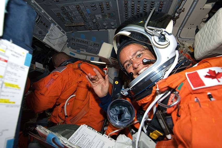 Julie Payette, STS-127 mission specialist, attired in her shuttle launch and entry suit, on the flight deck of Space Shuttle Endeavour during postlaunch activities in July 2009.