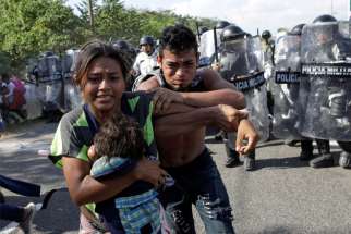 Migrants from Central America trying to reach the United States react as police approach them near Frontera Hidalgo, Mexico, Jan. 21, 2020. At least 138 Salvadorans have been murdered after being deported back to country from the United States, according to a report released Feb. 5 from Human Rights Watch.