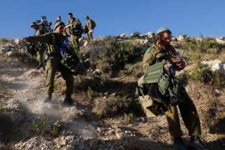 Israeli soldiers take part in an operation to locate three Israeli teens near the West Bank City of Hebron June 24. A Jerusalem church official urged people to come forward with information on the teens&#039; kidnapping but also urged Israel to keep its respo nse proportionate.