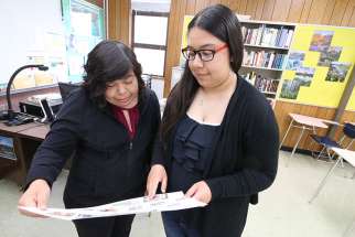 Aylin, a ninth-grader at La Salle Prep in Milwaukie, Ore., shares a recent school project in late May with her mother, Luz, who emigrated from Mexico. 