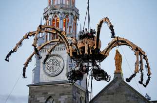 A giant mechanical spider is seen during an art performance in front of Notre-Dame Cathedral in Ottawa July 27.