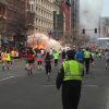 Runners head to finish line of the Boston Marathon as an explosion erupts nearby April 15. Two bombs exploded in the crowded streets near the finish line of the marathon, killing at least three people, including an 8-year-old boy, and injuring more than 140.