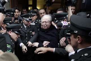 Chilean Father Fernando Karadima leaves after attending a 2015 hearing at the Supreme Court building in Santiago. A Sept. 28 Vatican statement said Pope Francis had expelled Karadima from the priesthood. 