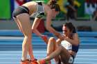 Nikki Hamblin, left, of New Zealand stops running during the race to help fellow competitor Abbey D&#039;Agostino of the U.S. after D&#039;Agostino suffered a cramp during the preliminary women&#039;s 5000m Round 1 in Rio de Janeiro on August 16, 2016.