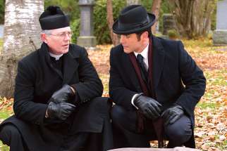 Fr. Keegan (guest star Peter Outerbridge), top left, and Murdoch (Yannick Bisson) discuss the murder scene beside the victim’s body in an episode of Murdoch Mysteries. The Fr. Keegan character is based on a priest that Murdoch author Maureen Jennings encountered during her years at Windsor’s Assumption University.
