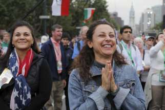 A woman reacts to Pope Francis&#039; final words during the closing Mass of the World Meeting of Families on the Benjamin Franklin Parkway in Philadelphia Sept. 27.