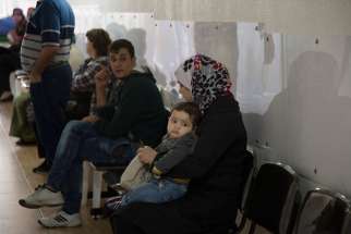 Patients wait for their turn to be treated at St. Anthony’s medical dispensary in Beirut. The clinic, run by the Good Shepherd Sisters, functions as a primary health care center, serving Iraqi and Syrian refugees, as well as Lebanon&#039;s poor.
