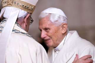 Pope Francis greets retired Pope Benedict XVI prior to the opening of the Holy Door of St. Peter&#039;s Basilica at the Vatican in 2015.