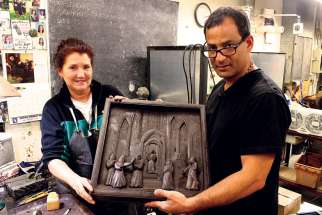 Sculptor Farhad Nargol O’Neil and Holly Atkinson display one of 20 panels for the new bronze doors.