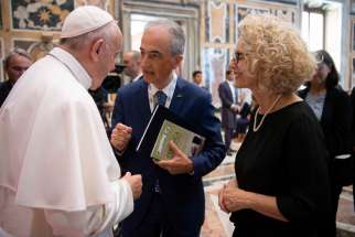 Pope Francis greets attendees during a meeting with doctors, patients and members of the Italian Association of Medical Oncology at the Vatican.