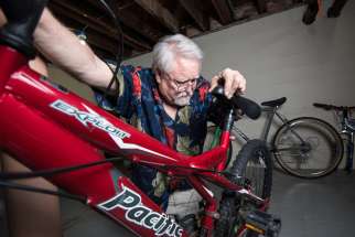 Tom Mayhew tests the brakes on a bicycle in the basement of St. John the Evangelist Church rectory in Green Bay, Wis. Mayhew, a retired dentist, was homeless and turned to the shelter after his practice went bankrupt. Now back on his feet, he says repairing bikes is a way for him to give back to the shelter.