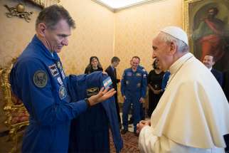 Pope Francis accepts a gift of a flight suit from Italian astronaut Paolo A. Nespoli during a meeting with astronauts from Expedition 53 of the International Space Station at the Vatican June 8. In October the pope spoke via a live link to the astronauts on the space station. 
