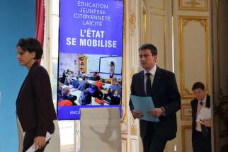 French Prime Minister Manuel Valls and Education and Research Minister Najat Vallaud-Belkacem arrive for a Jan. 22 news conference in Paris to announce new measures aimed at helping schools combat radical Islam, racism and anti-Semitism in reaction to deadly attacks. 