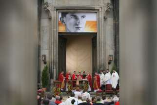 An image of Father Alois Andritzki hangs above the altar during his Mass of beatification in Dresden, Germany, June 13, 2011. The young German priest was executed in 1943 at the Nazi death camp of Dachau. In his sermon, Bishop Joachim Reinelt of Dresden-Meisse n praised Blessed Andritzki, saying he had shown a &quot;bright face&quot; while enduring the &quot;most awful beastly work&quot; at the concentration camp. (