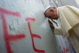 Pope Francis prays in front of the Israeli security wall in Bethlehem, West Bank, May 25. 
