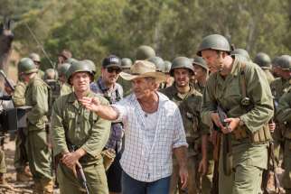 Director Mel Gibson, center, is seen on the set of &quot;Hacksaw Ridge.&quot; The movie marks Gibson&#039;s return to the director&#039;s chair after a 10-year absence.