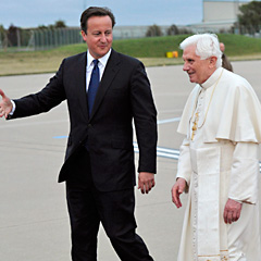 Pope Benedict XVI walks with British Prime Minister David Cameron