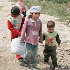 Syrian children and women arrive in Dabbabieh, in northern Lebanon. Civil strife and unrest has left hundreds of people dead in Syria.