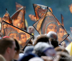 Images of Mary and the Christ Child are seen in the crowd attending an outdoor Mass celebrated June 5 by Pope Benedict XVI in Zagreb's hippodrome during a two-day visit to the Croatian capital.