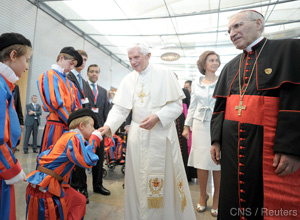 Pope Benedict XVI is welcomed by youths dressed as Swiss Guards after arriving after arriving at Madrid's Barajas airport Aug. 18.