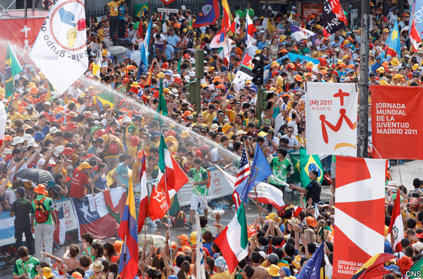 Pilgrims are sprayed with water before the start of the World Youth Day welcoming ceremony with Pope Benedict XVI in Plaza de Cibeles in Madrid Aug. 18.