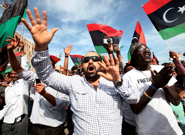 Libyans celebrate in Tripoli's Martyrs Square after hearing news that Libya's ousted leader Moammar Gadhafi was killed by fighters in Sirte, Libya, Oct. 20. Gadhafi's death was hailed as the moment of liberation of the oil-producing country that the strongman ruled for 42 years.