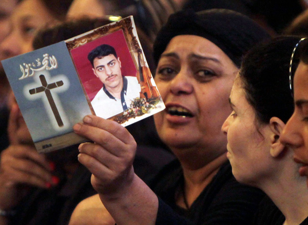 An Egyptian Christian woman shows a picture of her son during a funeral at Abassaiya Orthodox Cathedral in Cairo Oct. 10.