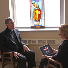 London Bishop Ronald Fabbro discusses Confession: A Roman Catholic App with Shelley Isabelle. The diocese was to give out 500 copies of the app as part of its April 6 Confession campaign. (Photo by Mark Adkinson)