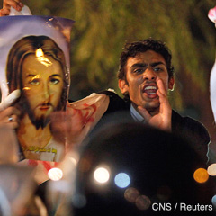 A Christian man shouts while holding an image of Christ during a Jan. 4 protest in Cairo. Angry protesters battled police as they demanded more protection following a New Year’s Day bombing at a Coptic Orthodox church. Prime Minister Stephen Harper has promised to fight religious persecution abroad. (CNS photo/Mohamed Abd El-Ghany, Reuters) 