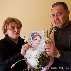 Jinan and Wafi Youssif hold a photo of their daughter Raghda, one of the victims of last October’s church massacre in Baghdad. (Photo by Fr. Don Doll, S.J.)
