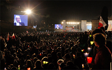 French Sister Marie Simon-Pierre appears on large monitors as she addresses a crowd gathered at Rome's Circus Maximus on the eve of the beatification of Pope John Paul II April 30. She recounted her cure from Parkinson's disease, the same illness that af fected the Polish pontiff. Her cure was accepted as the miracle that paved the way for his beatification.