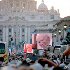 A massive crowd watches Pope John Paul II on video monitors during a World Youth Day celebration in St. Peter's Square at the Vatican in August 2000. A huge crowd is expected for the May 1 beatification.