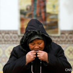 A Catholic woman prays during Mass at a church in Changzhi, Shanxi province, China. (CNS Photo/Reuters)