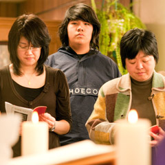 Members of Toronto's Japanese Catholic Community pray for victims of the earthquake that has ravaged their home country. (Photo by Michael Swan)
