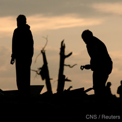 Residents search through debris of what was once their home after a devastating tornado hit Joplin, Mo.