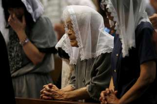 People pray for victims of the 1945 atomic bombing during an Aug. 9, 2015, Mass at the Urakami Cathedral in Nagasaki, Japan. Pope Francis will finally fulfill his desire to be a missionary to Japan when he visits the country, as well as Thailand, Nov. 20-26, 2019, the Vatican announced Sept. 13.